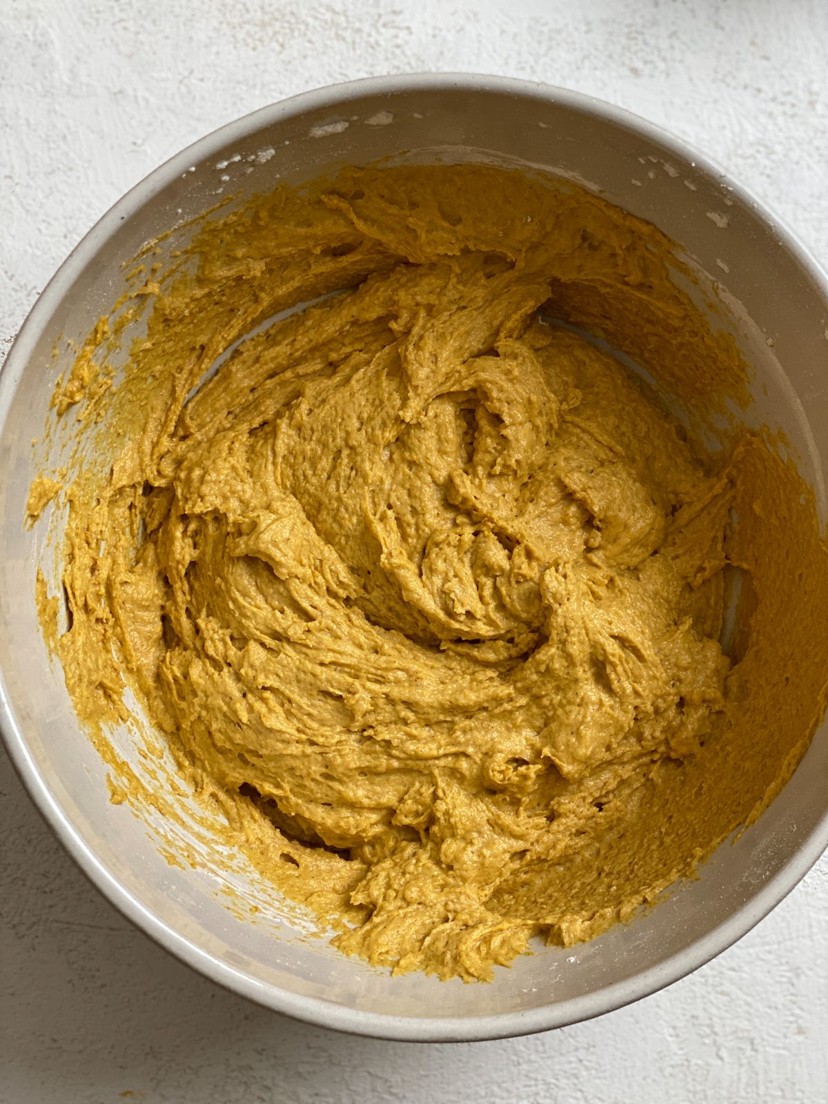 process shot of mixing Easy Vegan Pumpkin Muffins ingredients in a bowl