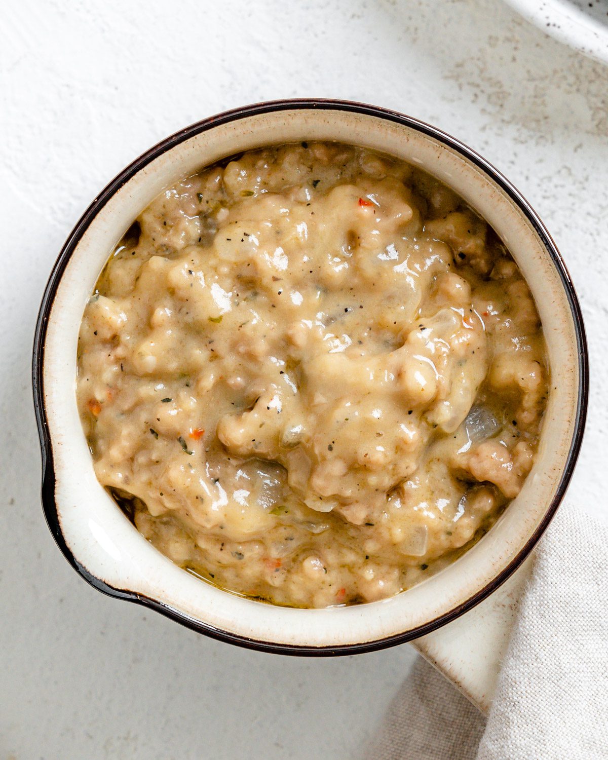 completed Vegan Sausage Gravy in a white bowl against a white surface