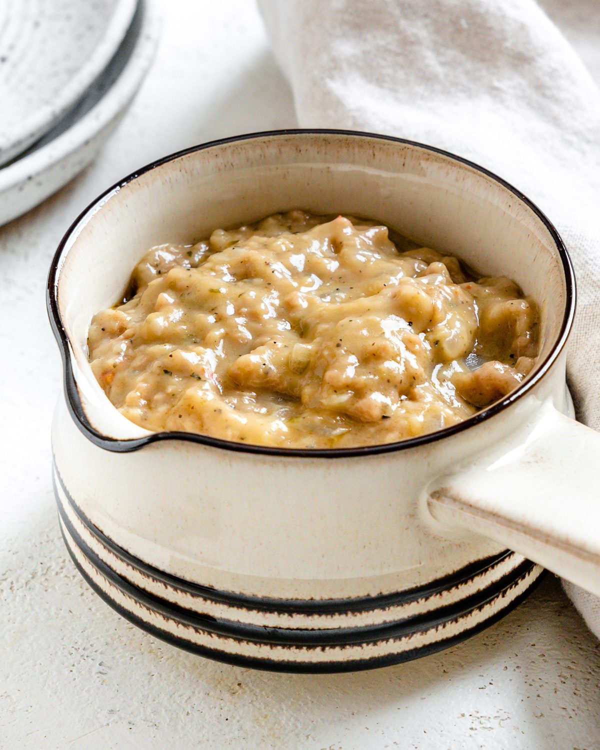 completed Vegan Sausage Gravy in a white bowl against a white surface