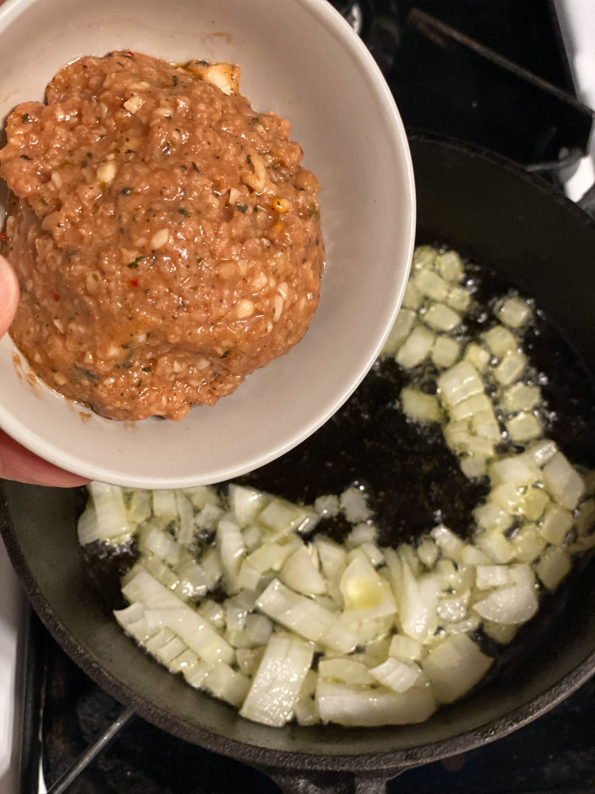 process shot of vegan sausage being poured into pan