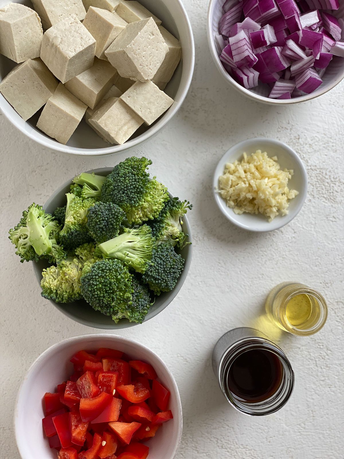 ingredients for Vegan Teriyaki Tofu Stir Fry measured out in bowls against a light surface
