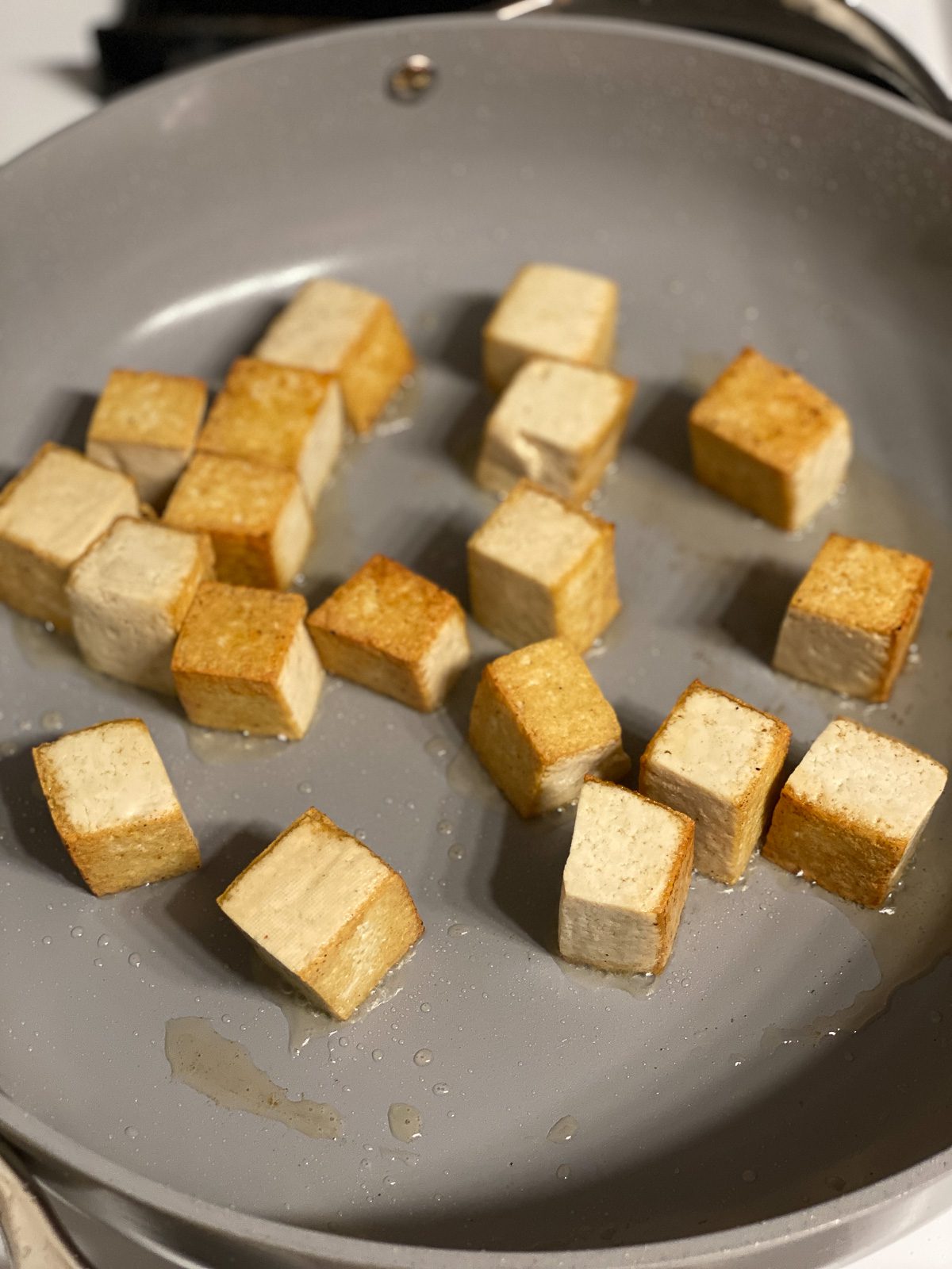 process of tofu cooking in pan