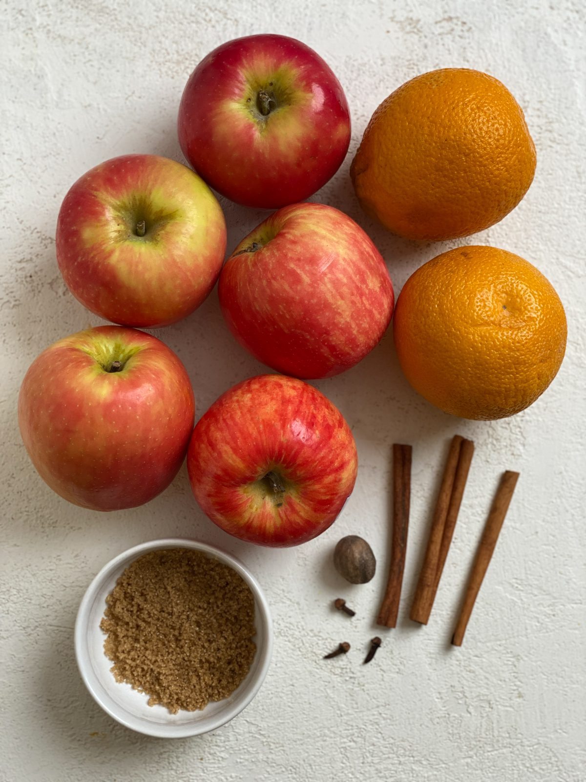 ingredients for Vegan Instant Pot Apple Cider against a white surface