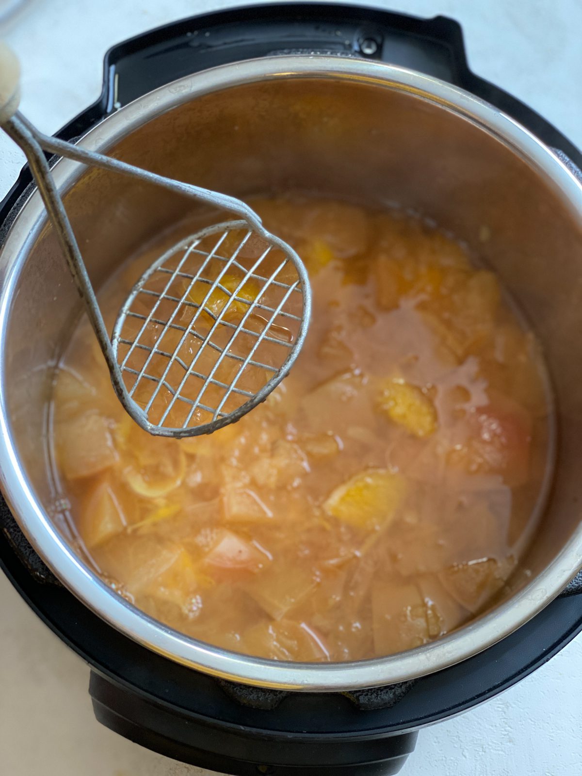 process of using potato masher on instant pot ingredients