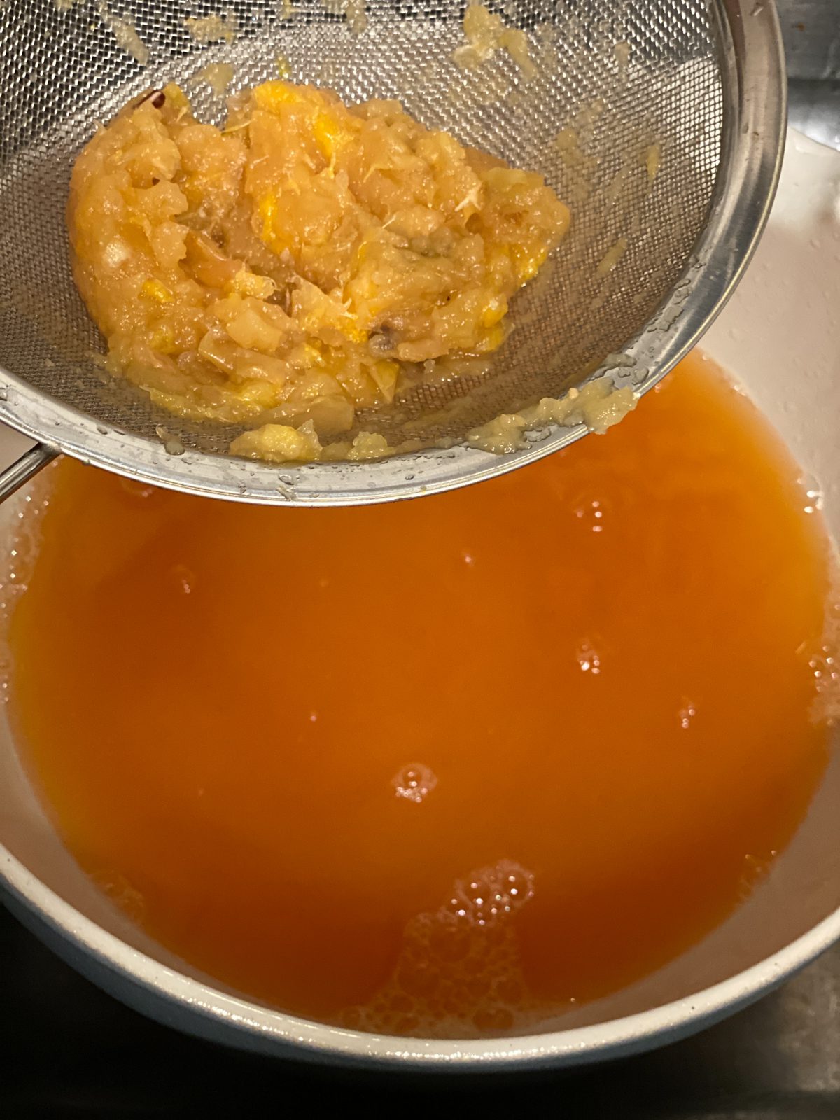 process of using strainer to filter out Vegan Instant Pot Apple Cider ingredients