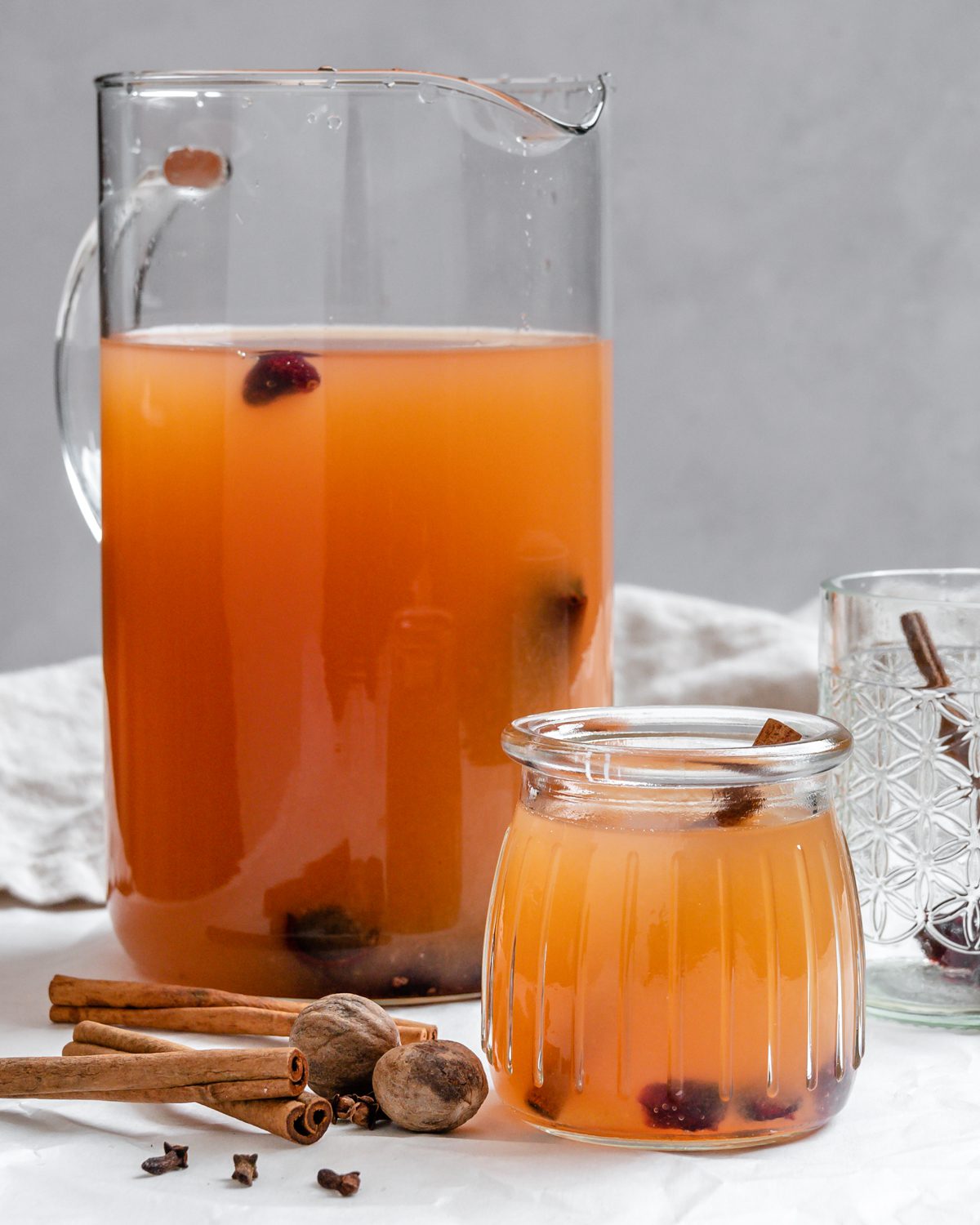 completed Vegan Instant Pot Apple Cider in two glass containers on a white surface