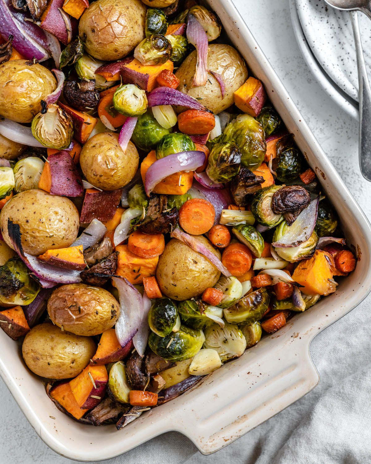 completed Roasted Vegetables in a baking dish against a light surface