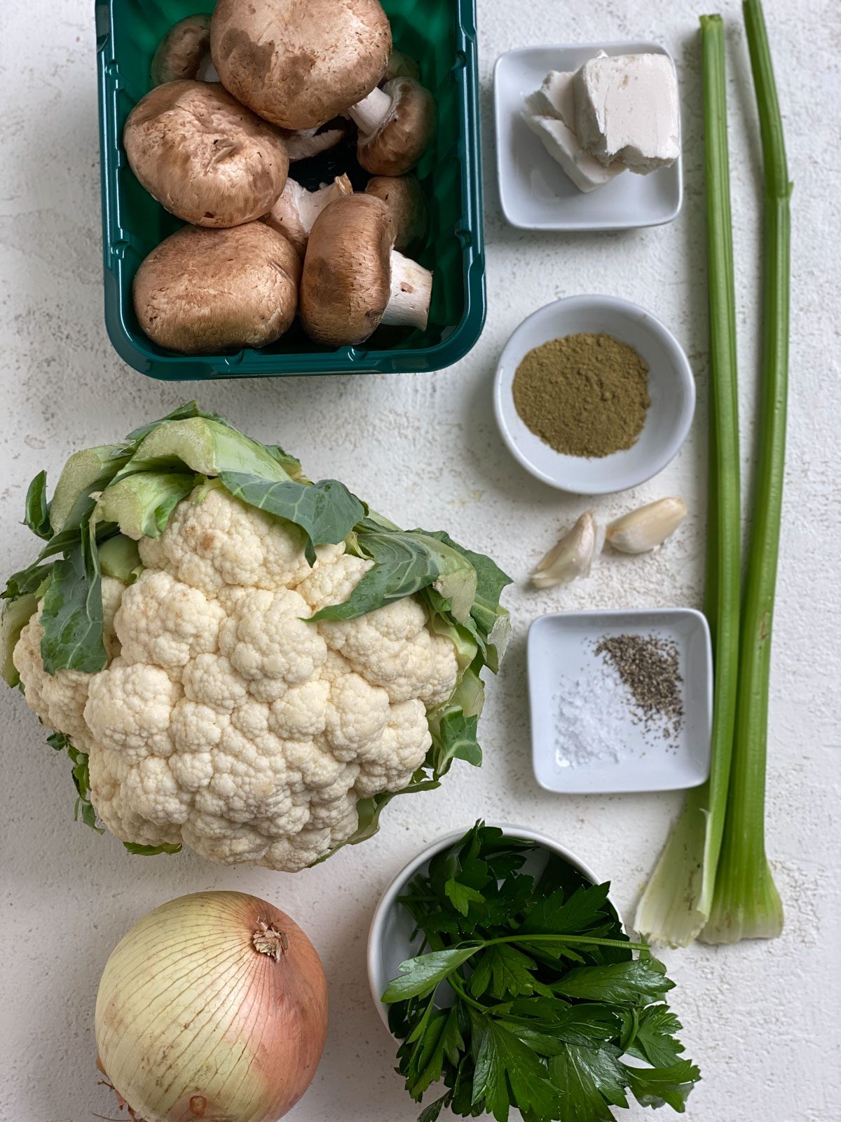 ingredients for Vegan Cauliflower Stuffing measured out against a white surface