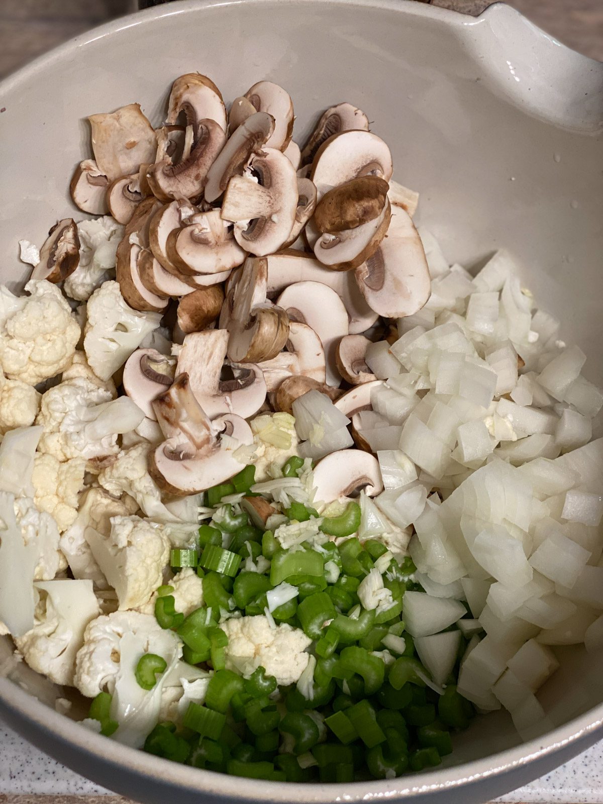 sliced ingredients for Vegan Cauliflower Stuffing in a bowl