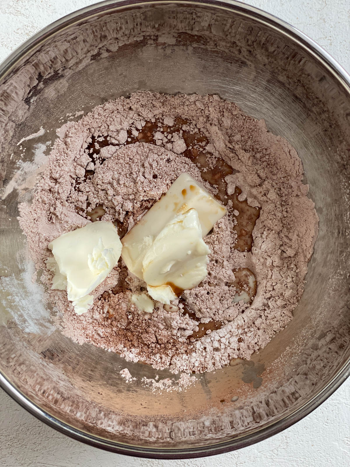 process shot of vegan butter added to ingredients in a bowl