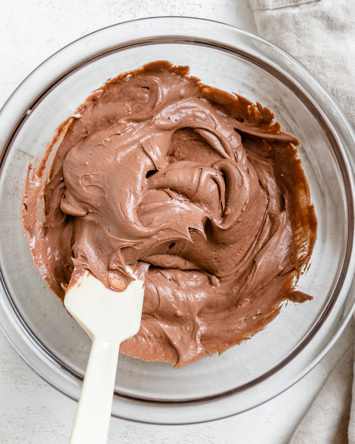 completed Vegan Chocolate Frosting in a bowl against a white background