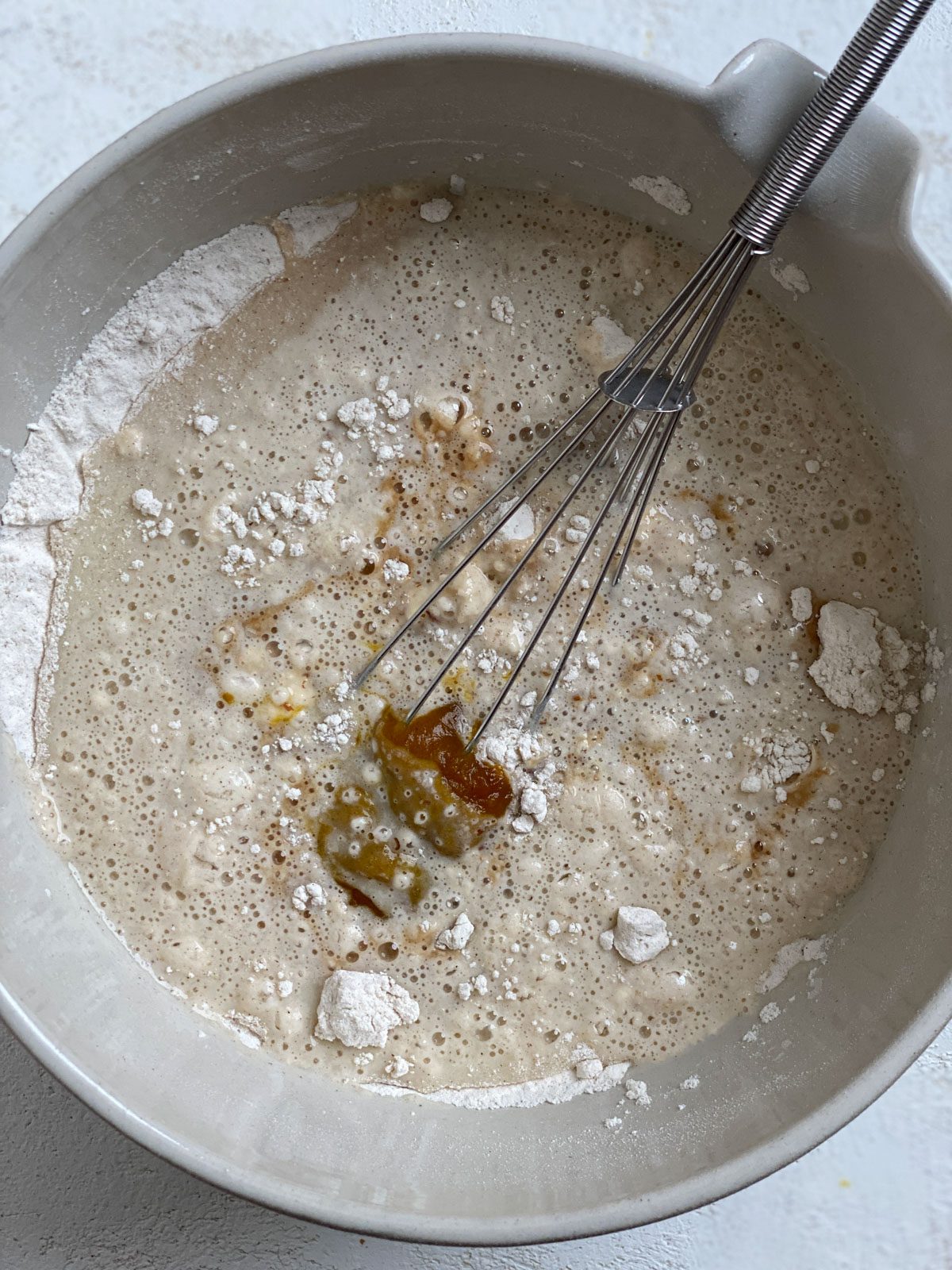 process shot of mixing Vegan Pumpkin Pancake ingredients in a light bowl