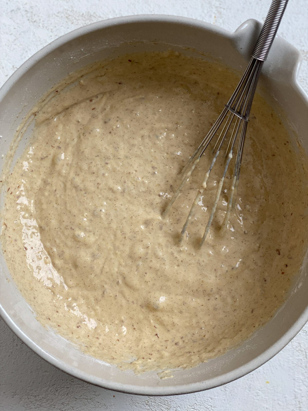 process shot of mixing Vegan Pumpkin Pancake ingredients in a light bowl