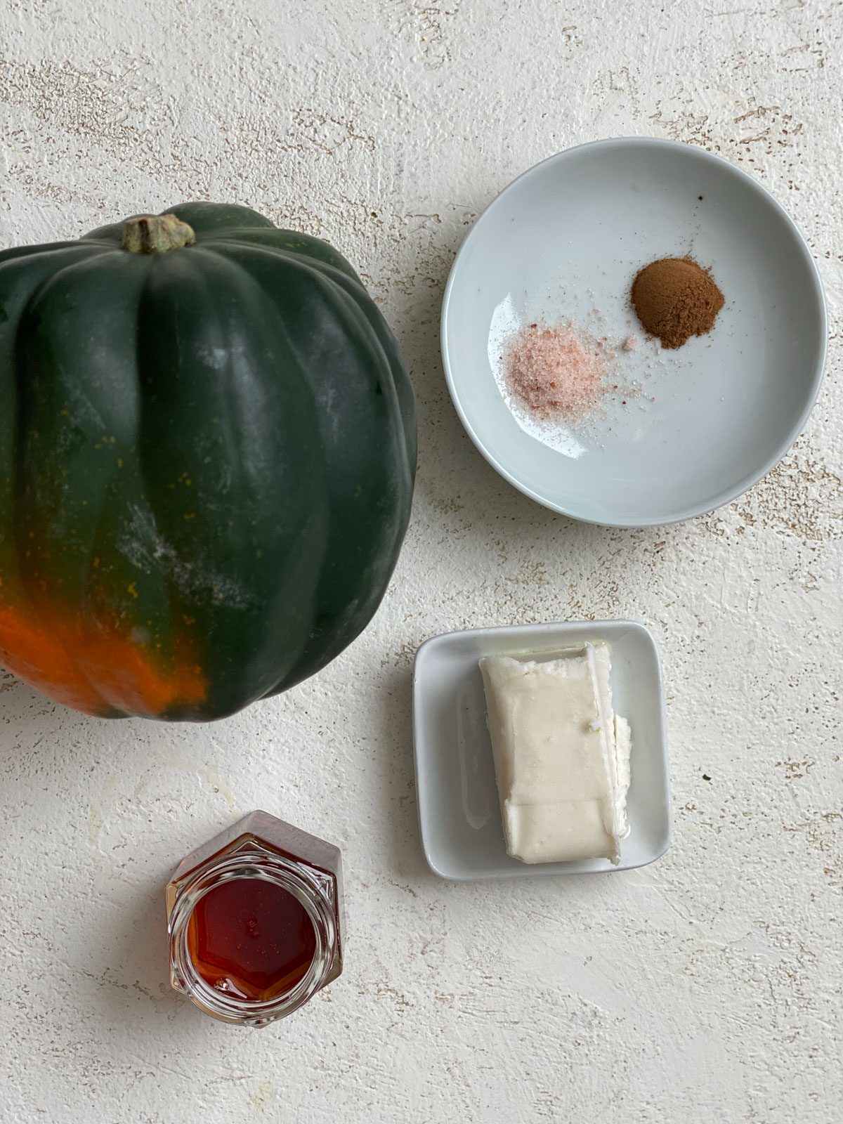 ingredients for Easy Air Fryer Acorn Squash measured out against a light surface