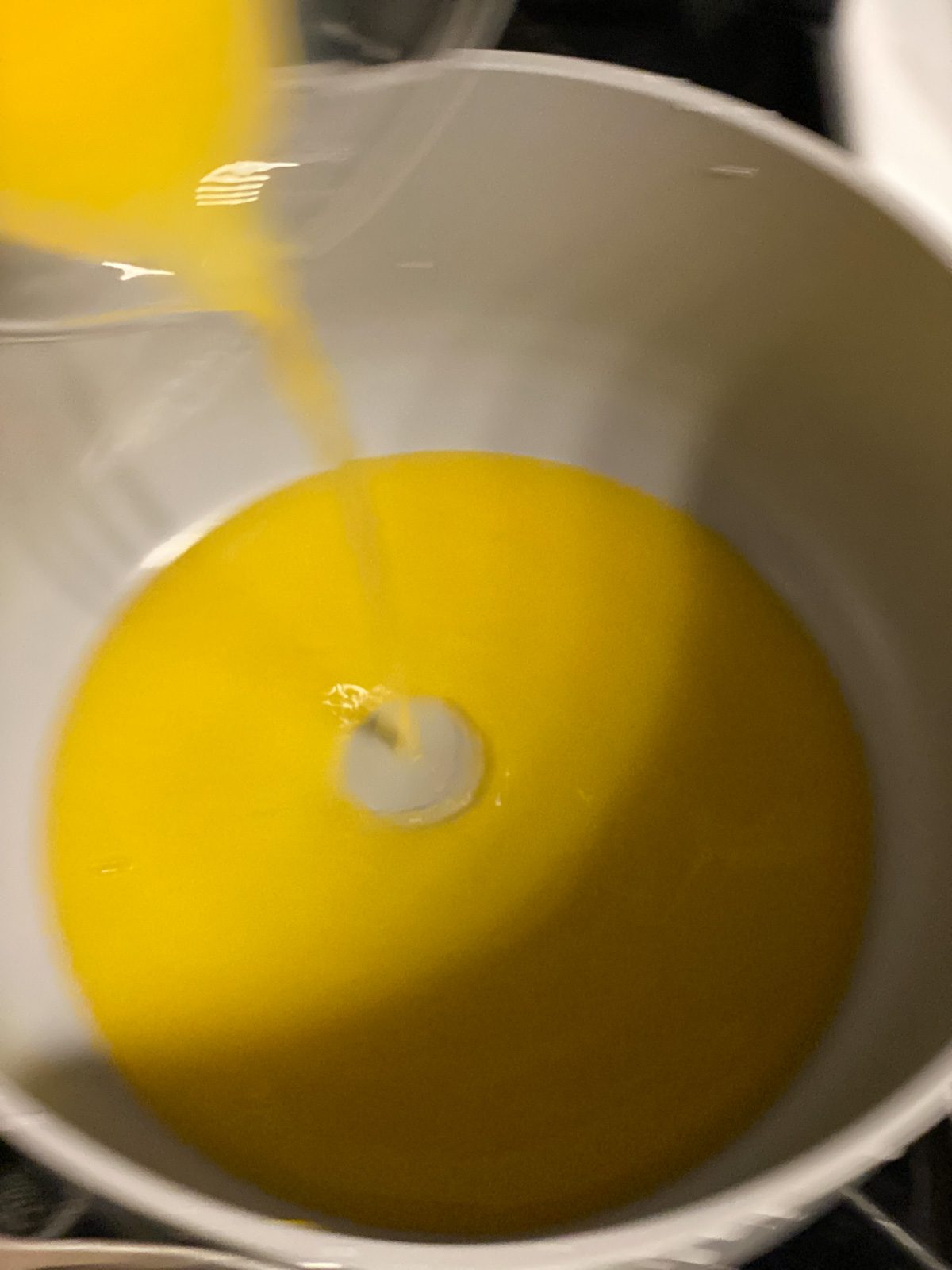 process shot of pouring orange juice into pan