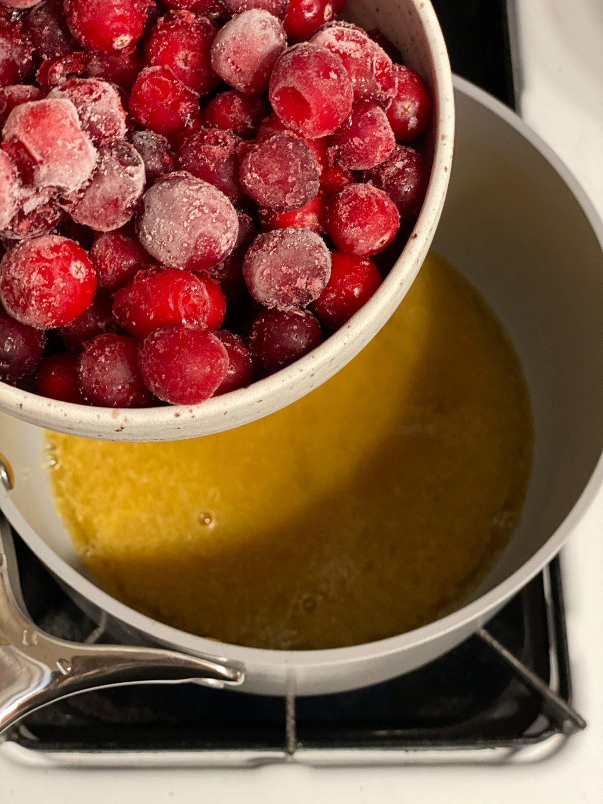 process shot of adding cranberries to pan