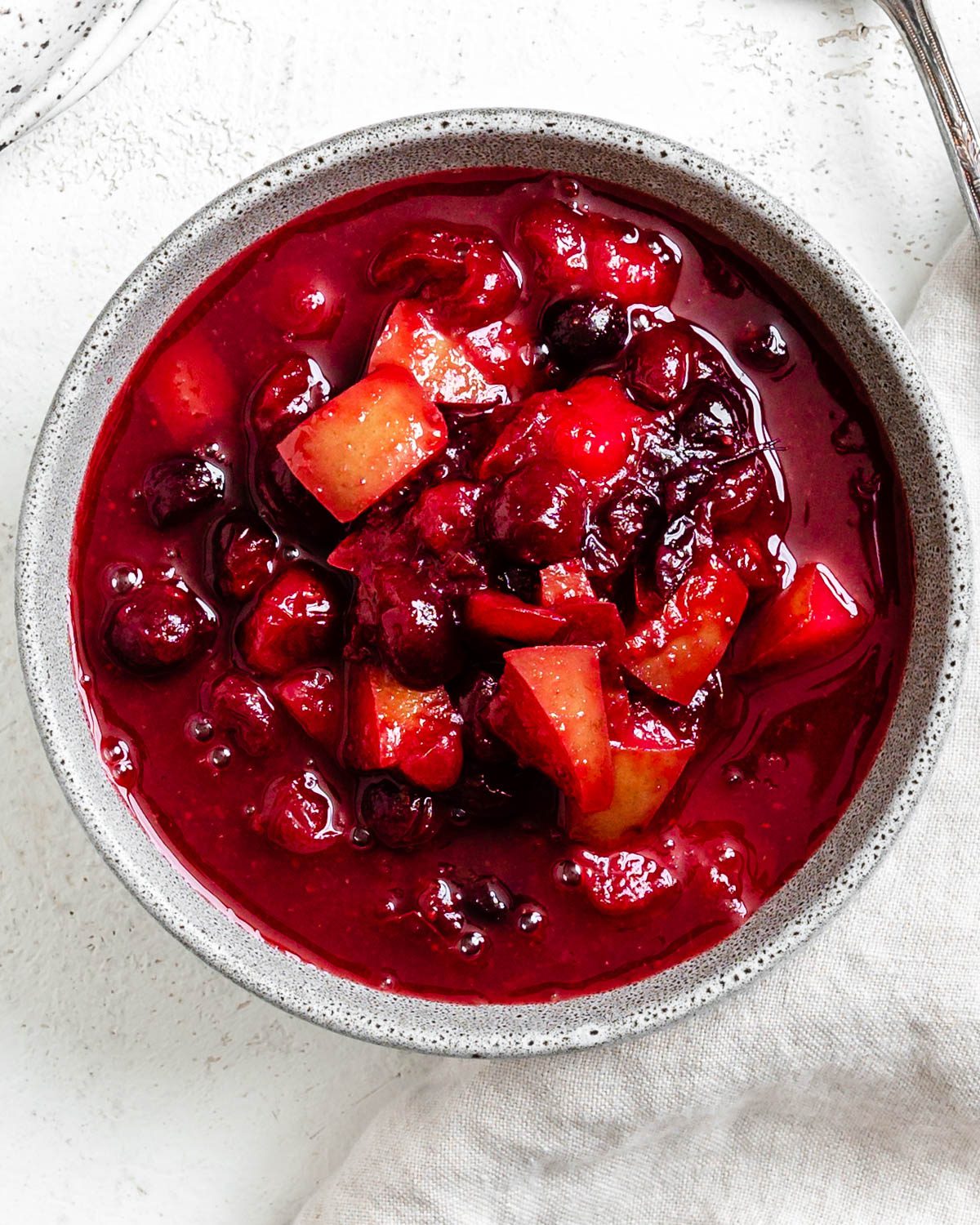 completed Easy Cranberry Pear Sauce in a bowl against a white surface