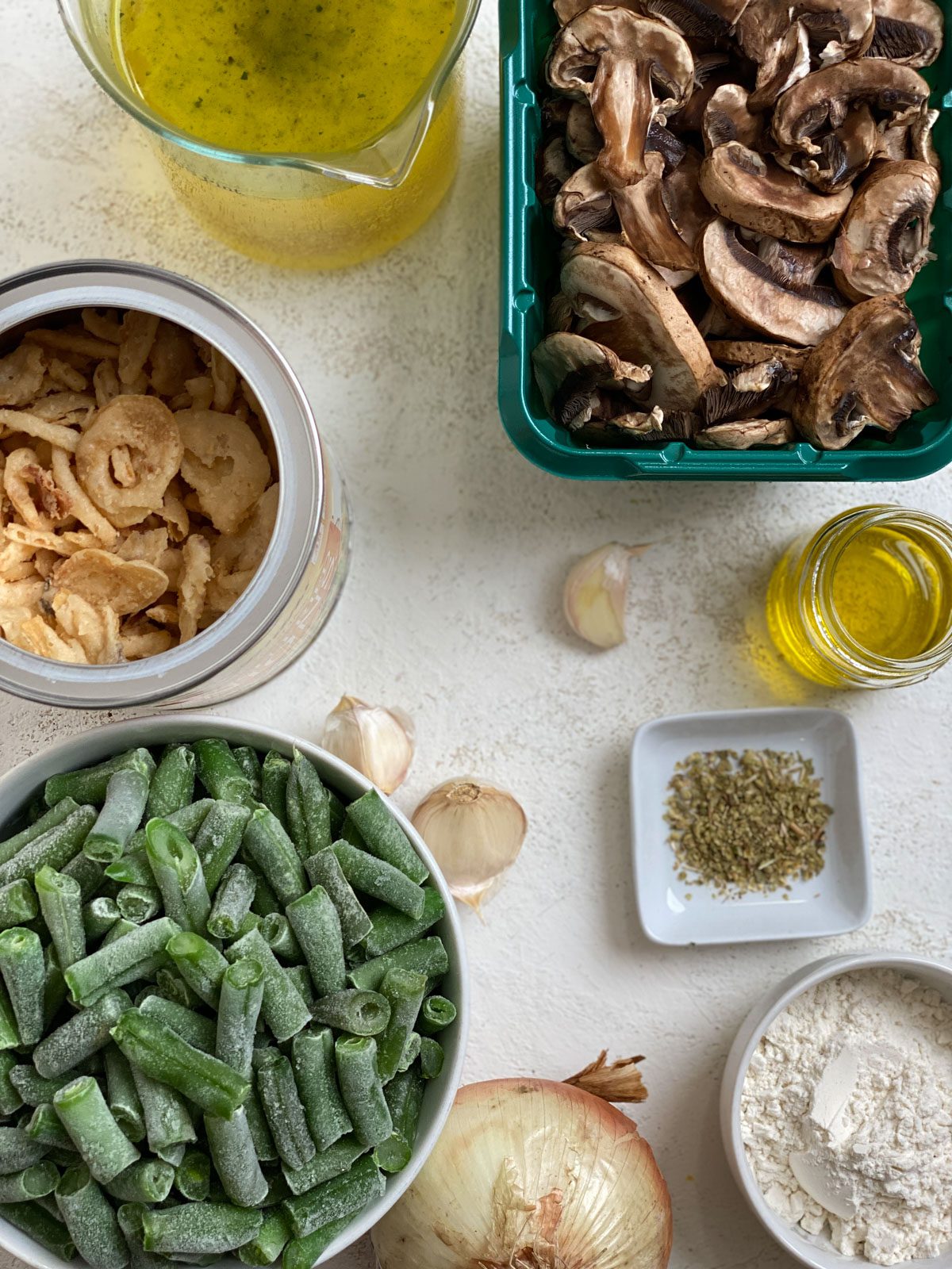 ingredients for Dairy-Free Green Bean Casserole measured out against a white surface
