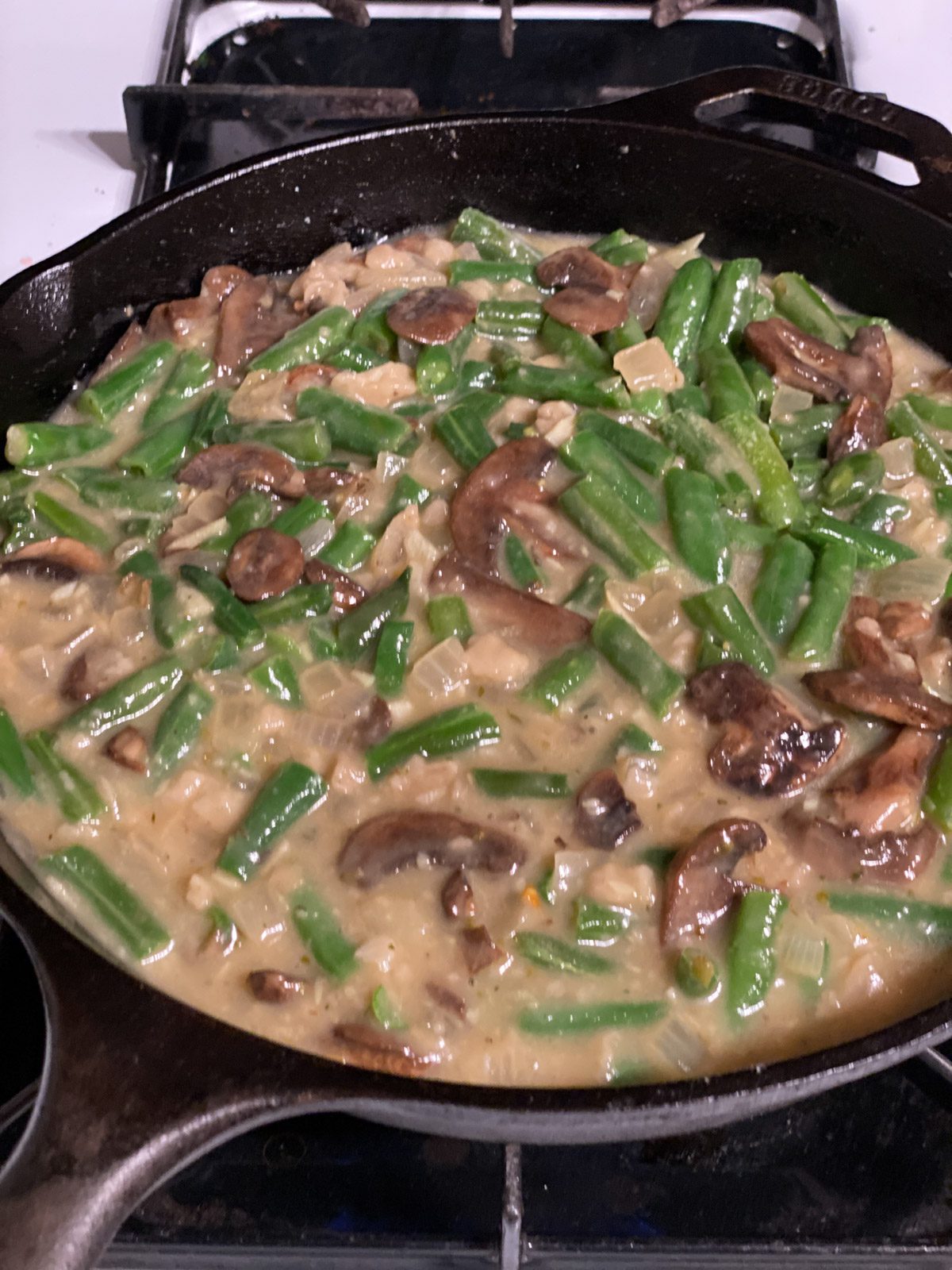 process shot of green bean casserole mixture cooking in a pan