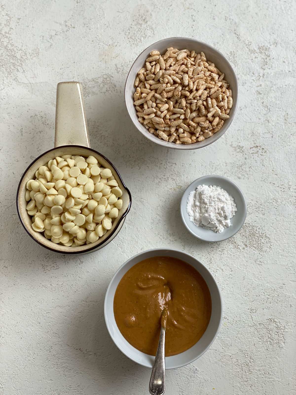 ingredients for Peanut Butter Balls with Rice Krispies against a white surface