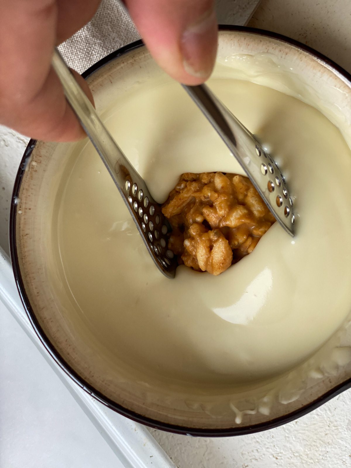 process shot of mixing cookie balls into dip