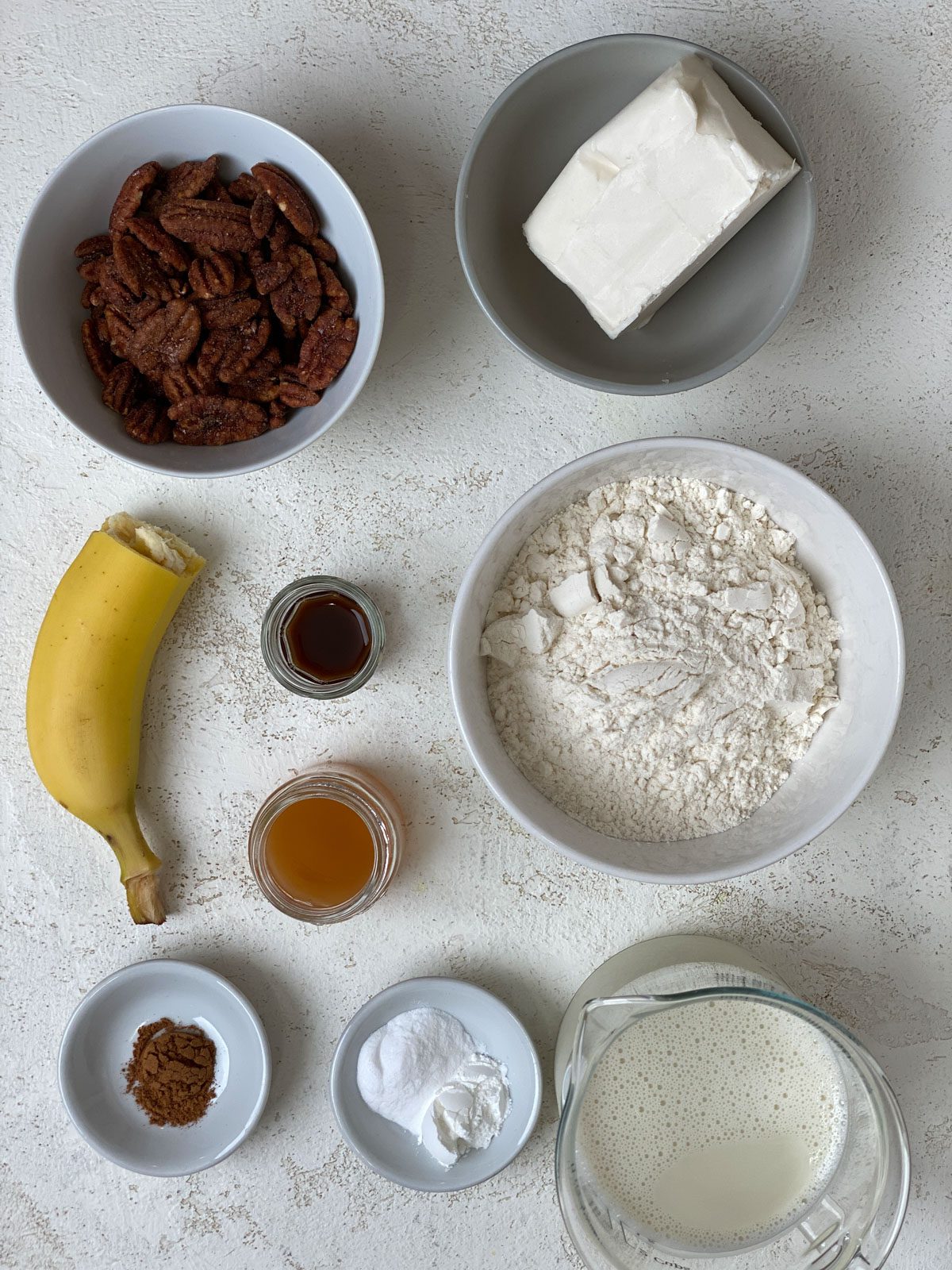 ingredients for Vegan Cinnamon and Banana Pecan Muffins measured out against a white surface