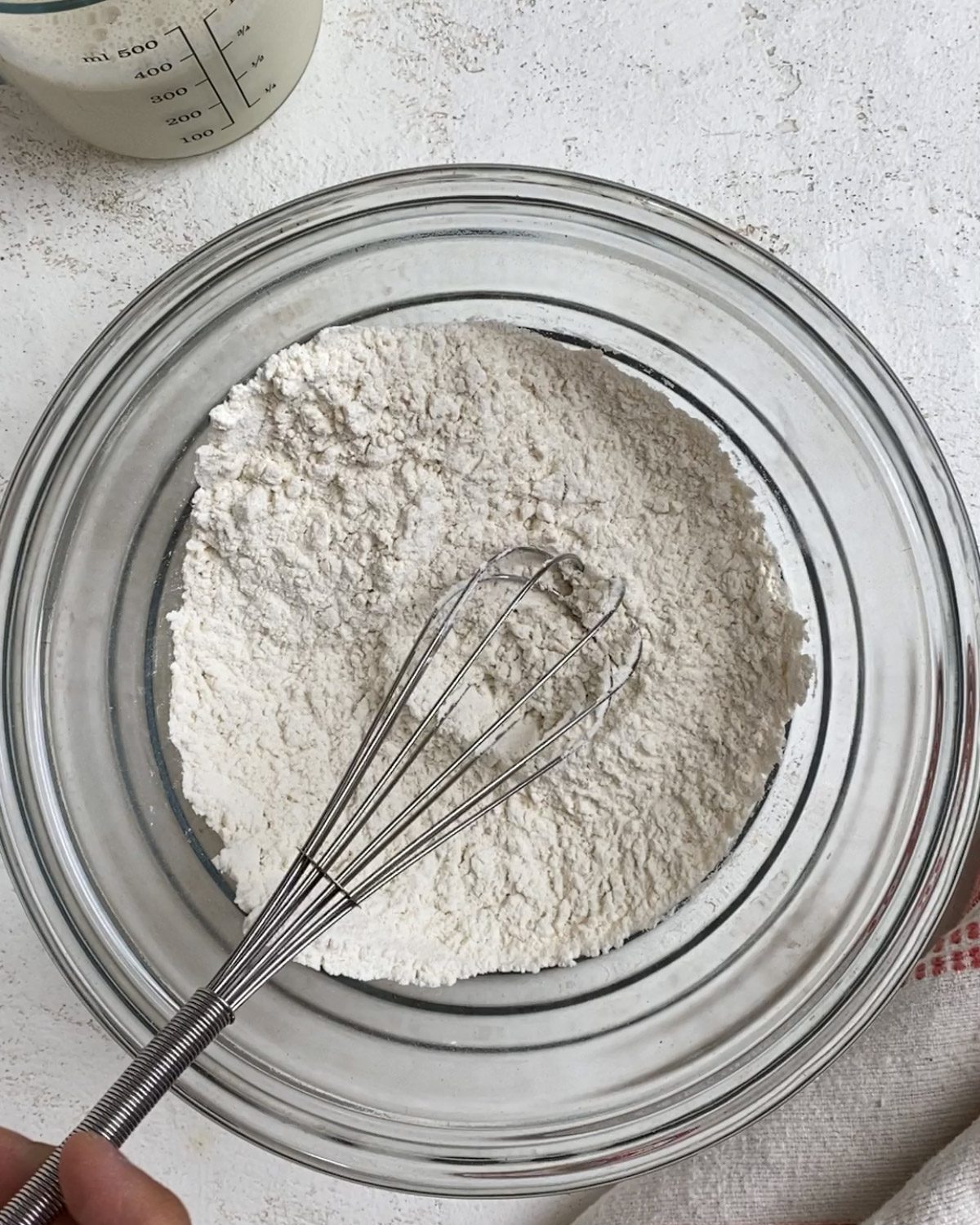 process of mixing flour and leavening agent ingredients in bowl