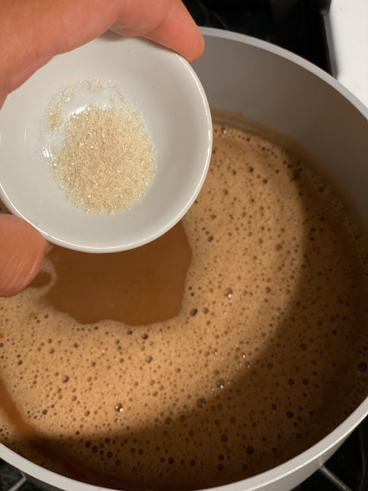 process shot of adding sugar to the pot