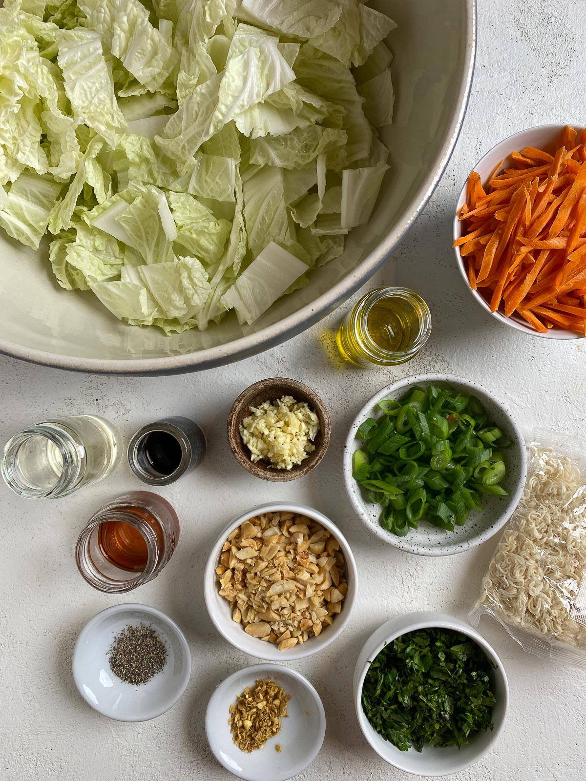 ingredients for Ramen Noodle Cabbage Salad measured out against a white surface