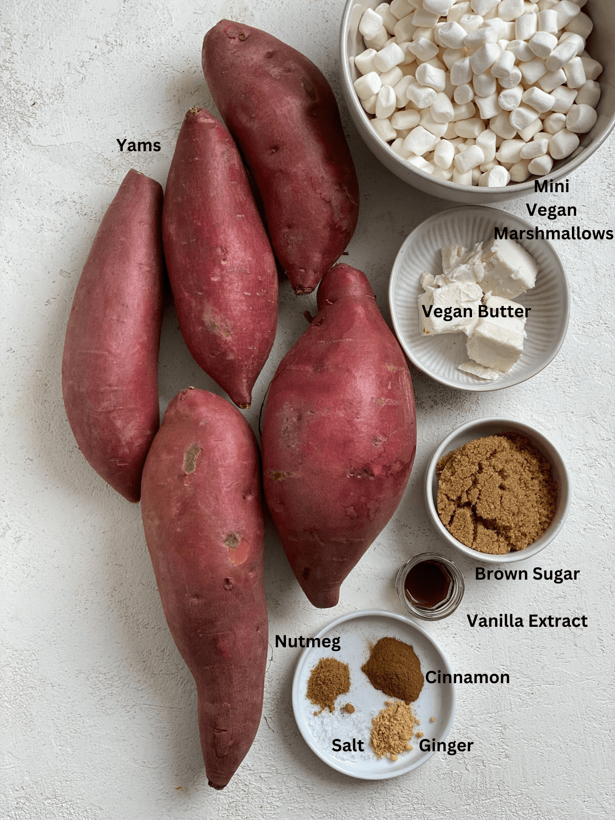 Ingredients for Vegan Candied Yams with Marshmallows measured out on a white surface.