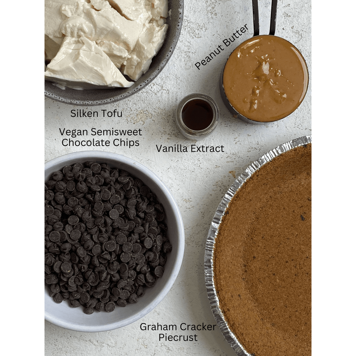 ingredients for Easy Vegan Chocolate Peanut Butter Pie measured out against a white surface