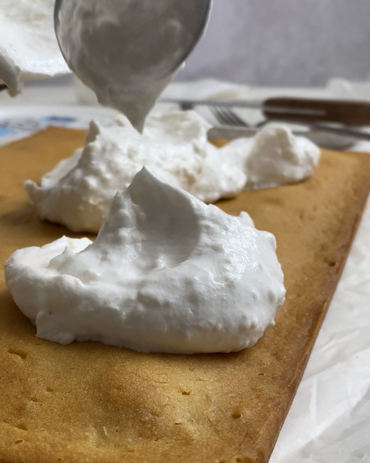 process shot of adding vegan whipped cream to cake