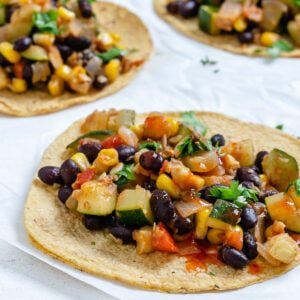 completed Vegan Black Bean Tacos with Veggies against a white surface