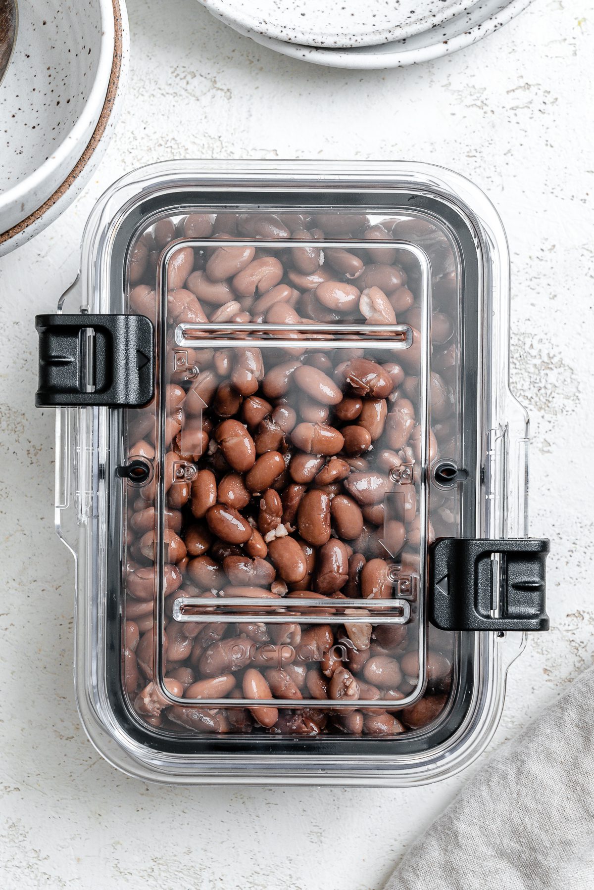 completed beans in a container against a white background