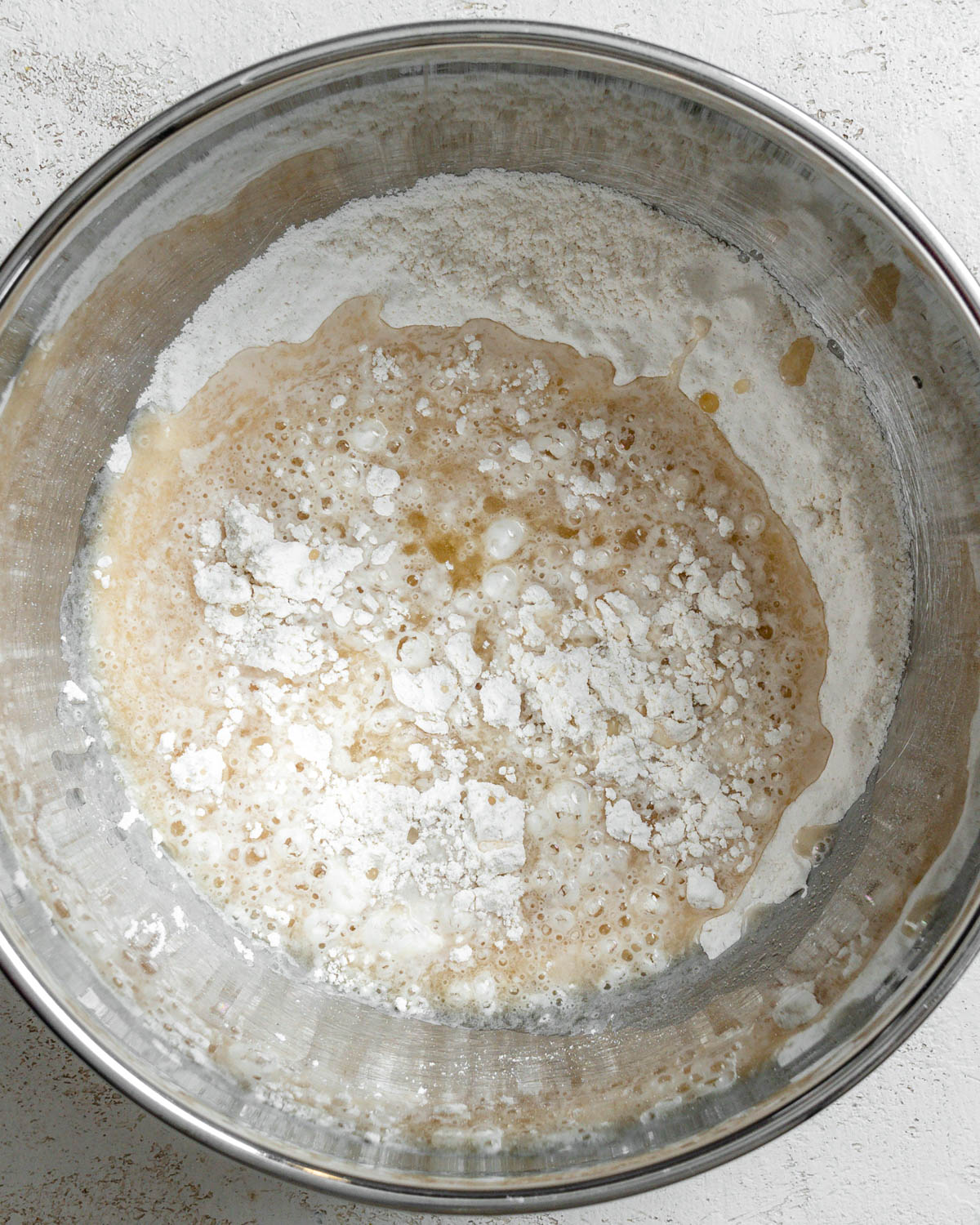 process shot of adding flour mixture to bowl