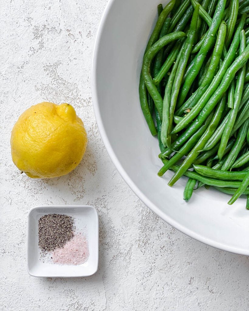 ingredients for Instant Pot Green Beans [Fresh or Frozen] measured out against a white surface