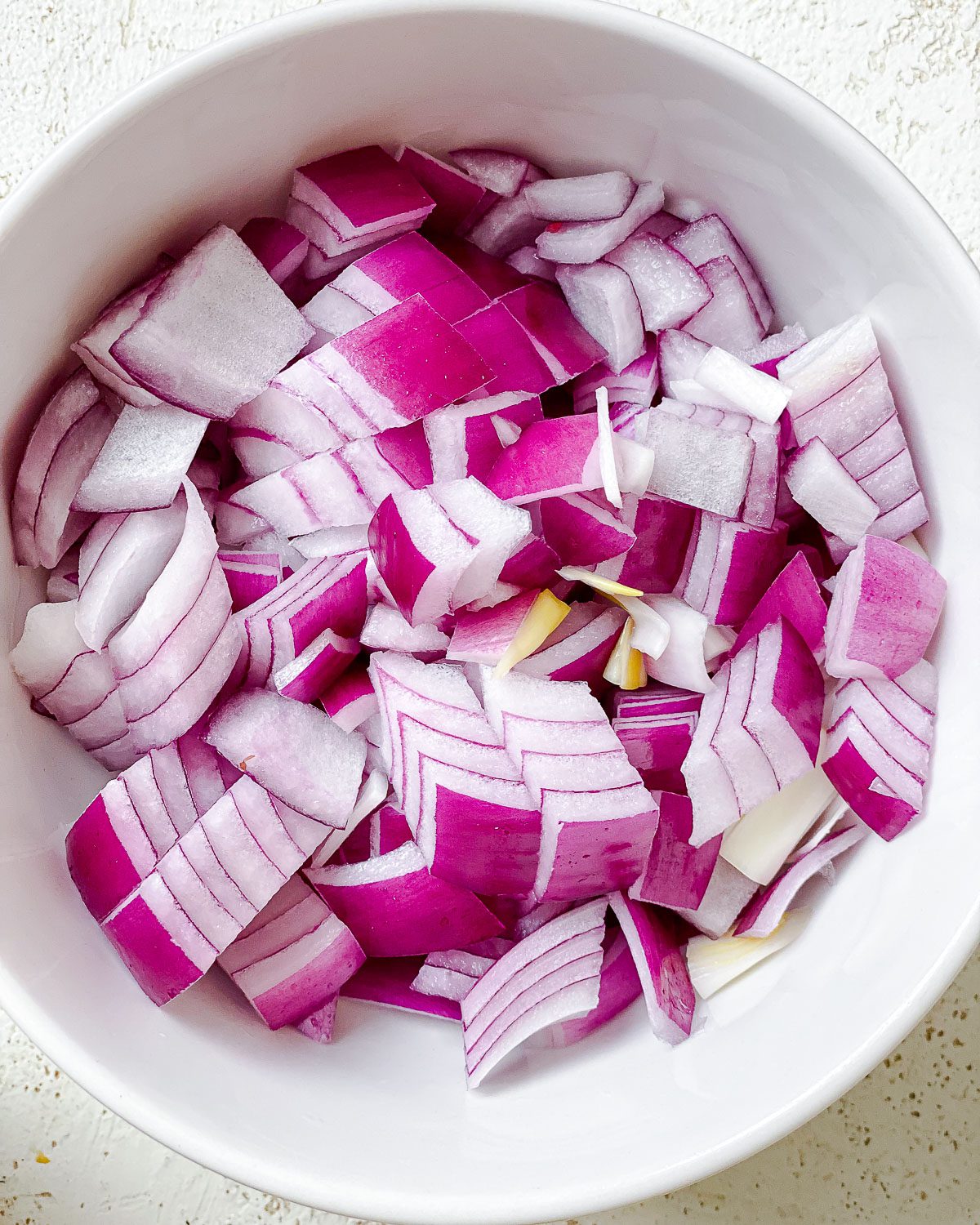 chopped onions for Easy Vegan Taco Soup in a bowl