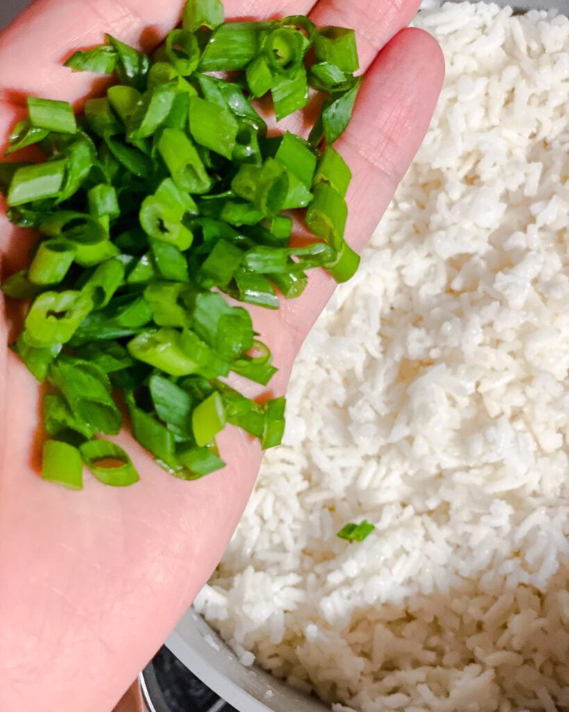 process shot of adding green onions to rice