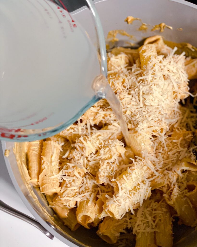 process shot of adding pasta water to pan