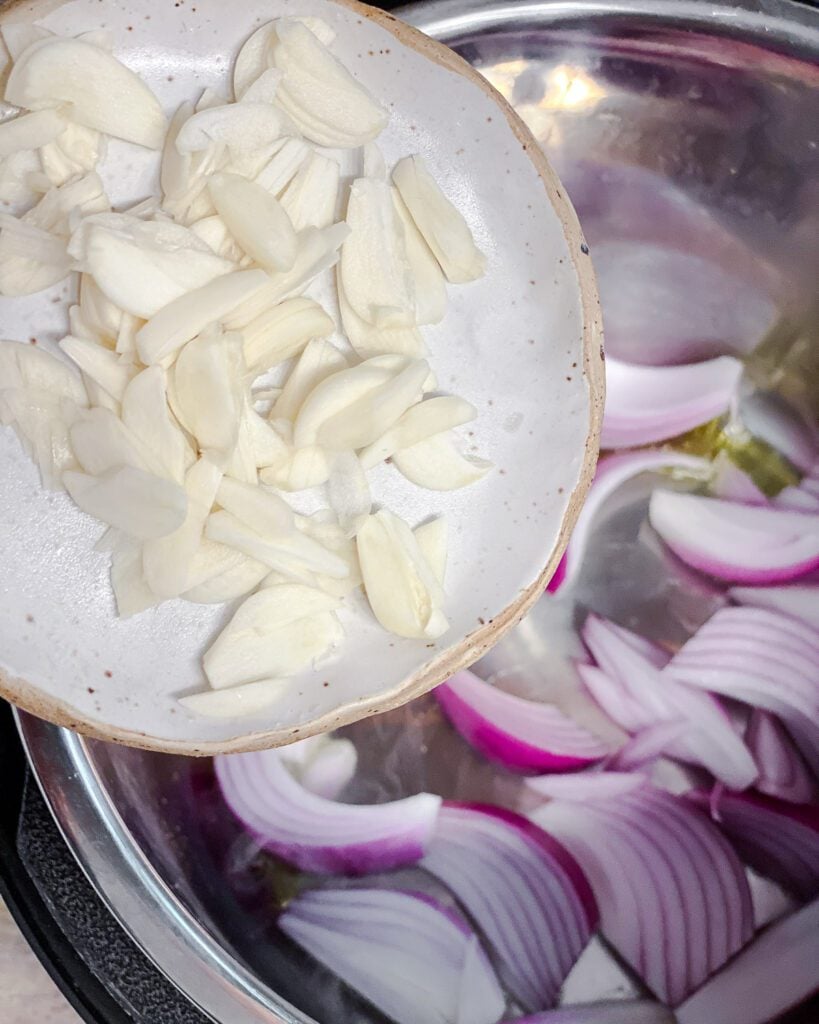 process shot of adding onions to pot