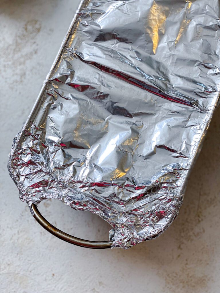 process shot showing addition of foil over meat loaf pan