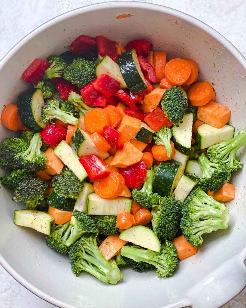 veggies added to a white bowl