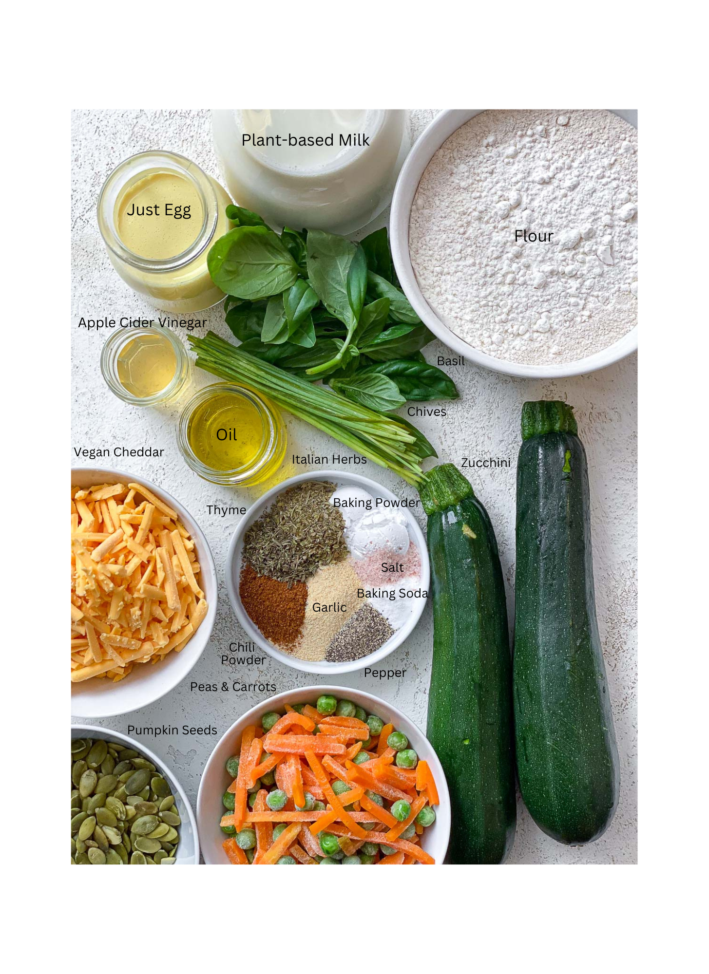 ingredients for Healthy Veggie Muffins measured out against a white surface