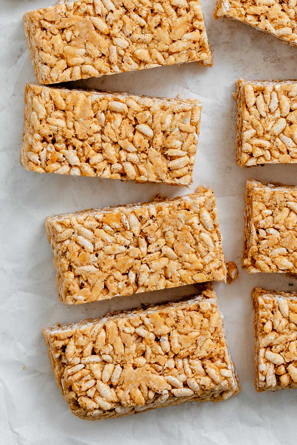 several completed Peanut Butter Rice Krispie Treats against a white surface