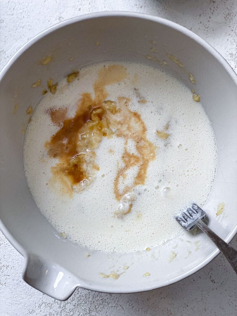 process shot of mixing wet ingredients together in a bowl