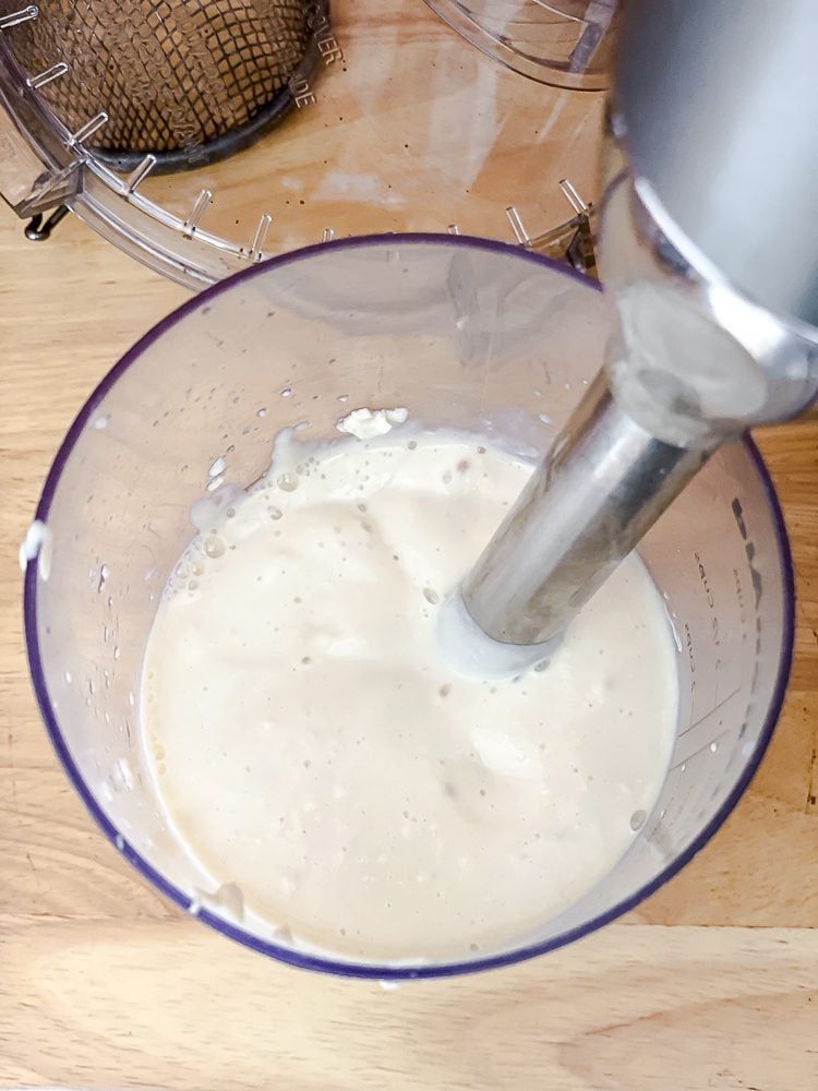 process shot of using immersion blender in container