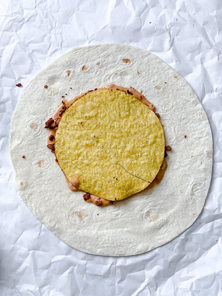 process shot showing corn tortilla added to crunchwrap
