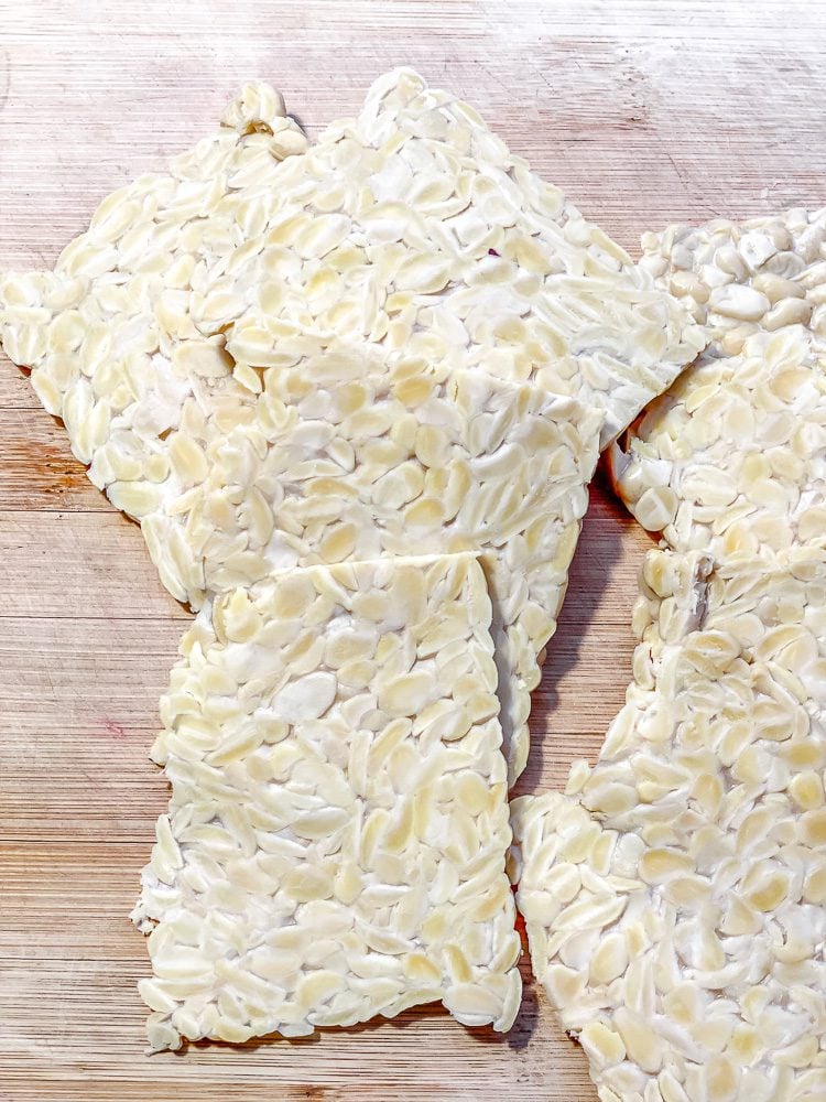 several slices of tempeh on cutting board