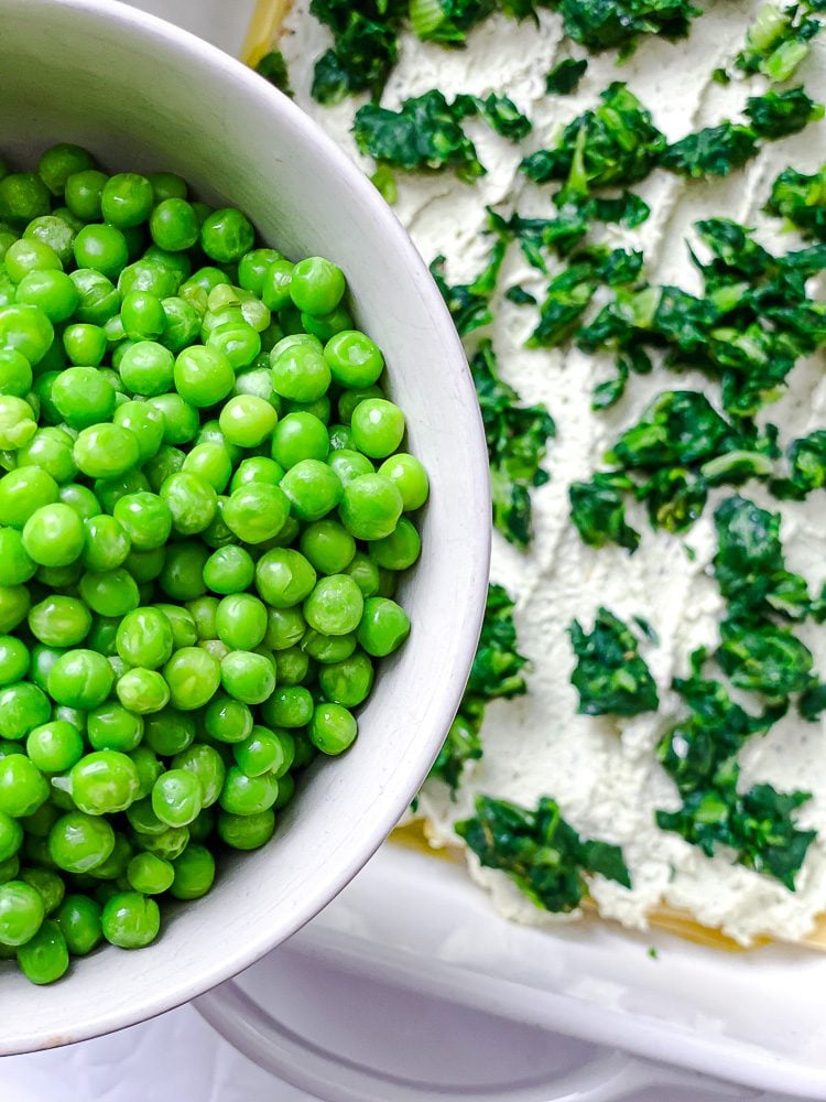 process shot showing peas being added to dish