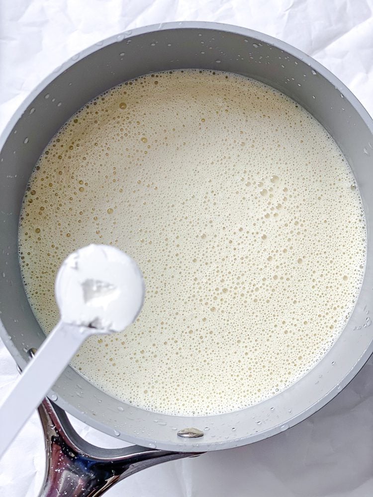 process shot of cornstarch being added to pan